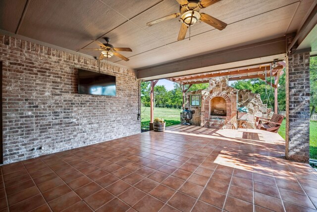 109 Rio Bravo Ct, Weatherford, TX 76088 - view of patio / terrace featuring an outdoor stone fireplace and a ceiling fan