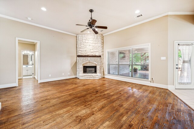 109 Rio Bravo Ct, Weatherford, TX 76088 - unfurnished living room with a ceiling fan, crown molding, a fireplace, wood finished floors, and baseboards