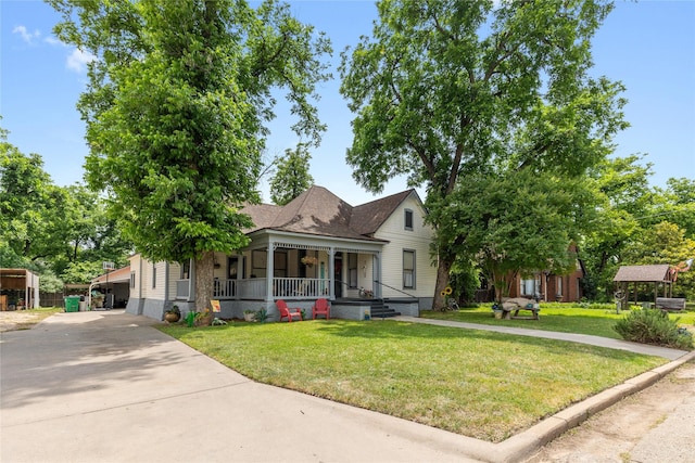 517 W College Ave, Coleman, TX 76834 - view of front of property with a porch, concrete driveway, and a front lawn