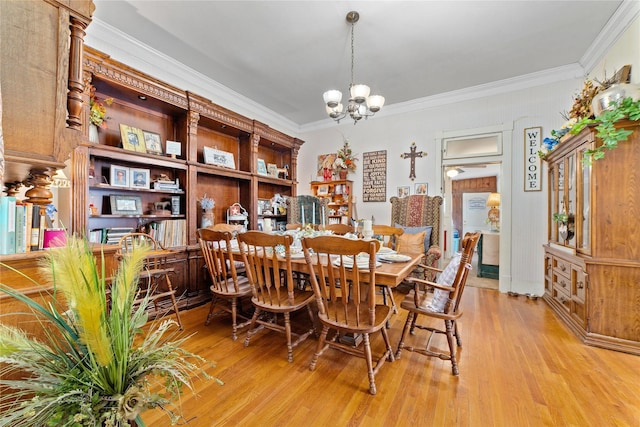 517 W College Ave, Coleman, TX 76834 - dining area with a chandelier, crown molding, and light wood-style floors