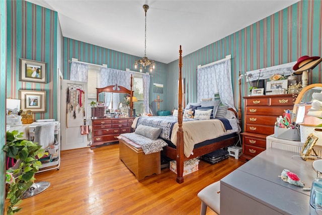 517 W College Ave, Coleman, TX 76834 - bedroom featuring wallpapered walls, a chandelier, and wood-type flooring