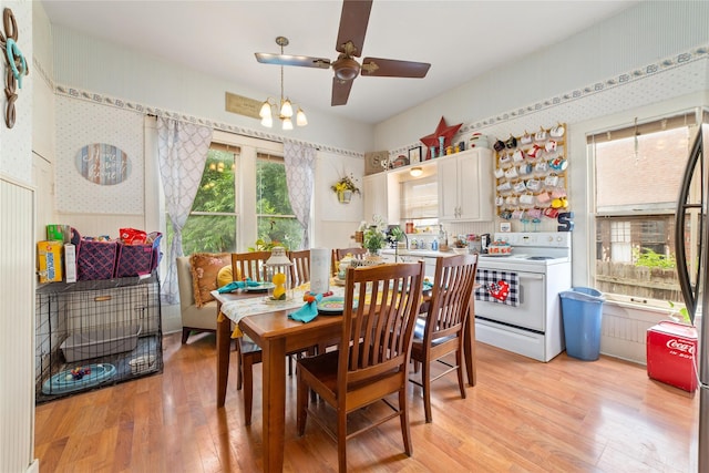 517 W College Ave, Coleman, TX 76834 - dining room featuring wallpapered walls, light wood-style flooring, a ceiling fan, and a chandelier