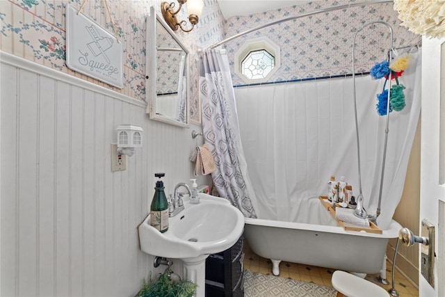 517 W College Ave, Coleman, TX 76834 - bathroom featuring wallpapered walls, a freestanding bath, a shower with curtain, tile patterned floors, and a sink