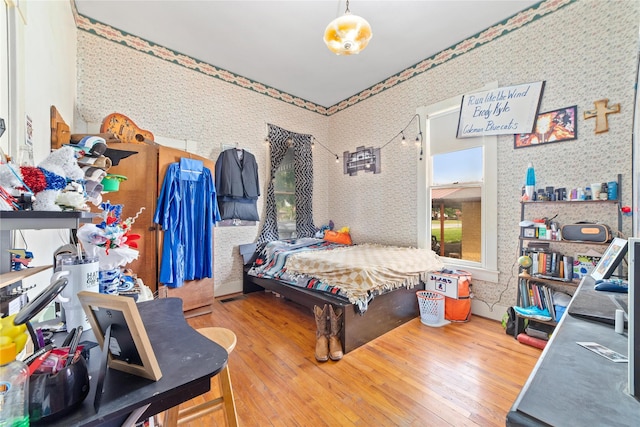 517 W College Ave, Coleman, TX 76834 - bedroom featuring hardwood / wood-style floors and wallpapered walls