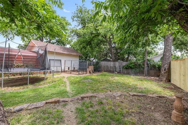 517 W College Ave, Coleman, TX 76834 - view of yard with a trampoline and a detached garage