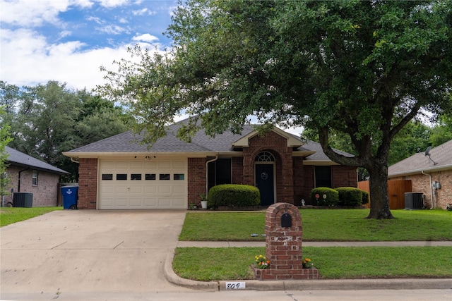 809 Oak Dr, Ennis, TX 75119 - view of front of house featuring a garage, concrete driveway, a front lawn, and brick siding