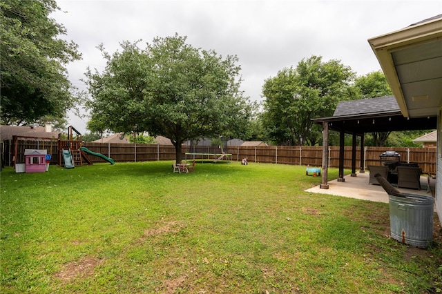 809 Oak Dr, Ennis, TX 75119 - view of yard featuring a playground, a trampoline, and a patio area