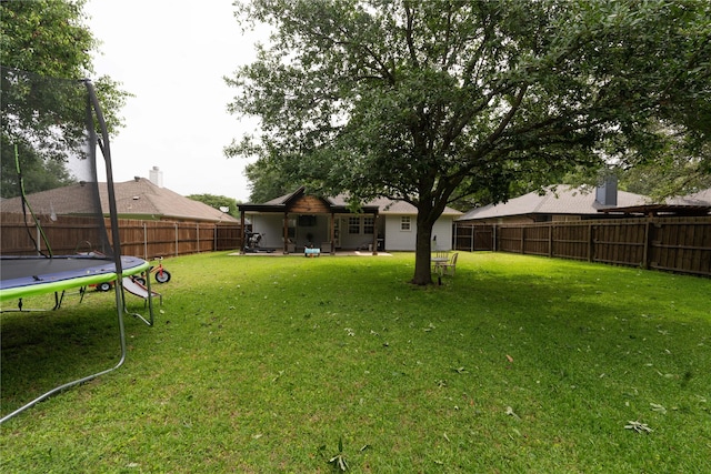 809 Oak Dr, Ennis, TX 75119 - view of yard featuring a trampoline and a patio area