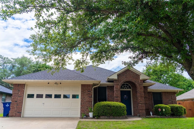 809 Oak Dr, Ennis, TX 75119 - view of front of house with concrete driveway, an attached garage, brick siding, and a shingled roof