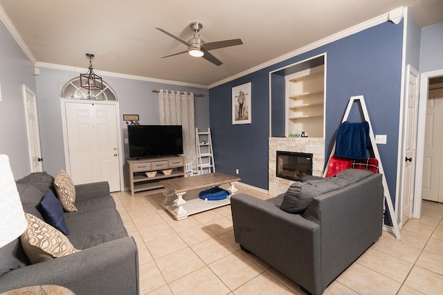 809 Oak Dr, Ennis, TX 75119 - living area with light tile patterned flooring, ceiling fan, built in features, crown molding, and baseboards