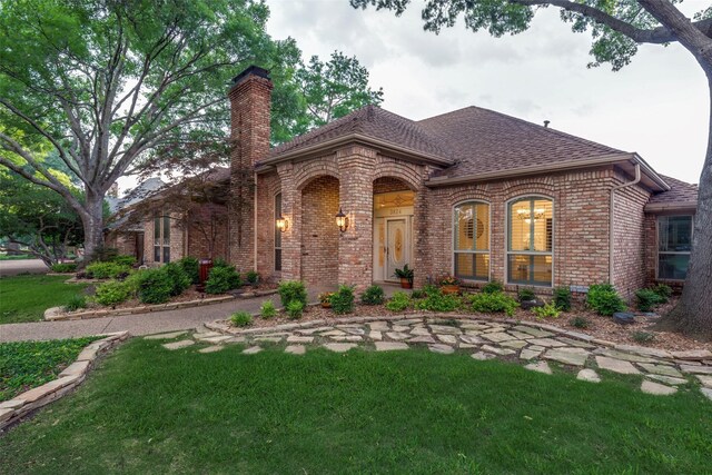 3824 Wyeth Dr, Plano, TX 75023 - view of front of property with a chimney, brick siding, a front yard, and a shingled roof