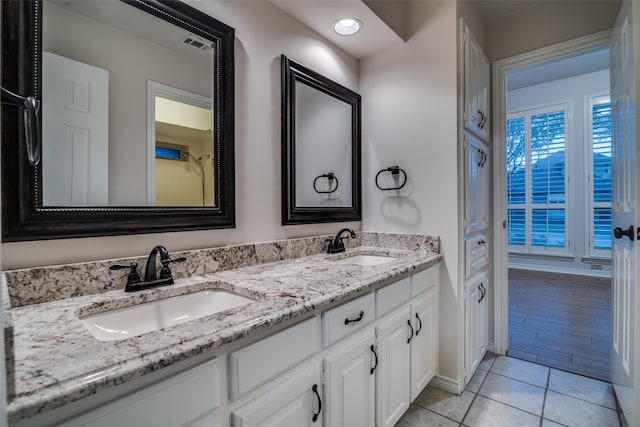 3824 Wyeth Dr, Plano, TX 75023 - bathroom featuring double vanity, baseboards, and tile patterned floors