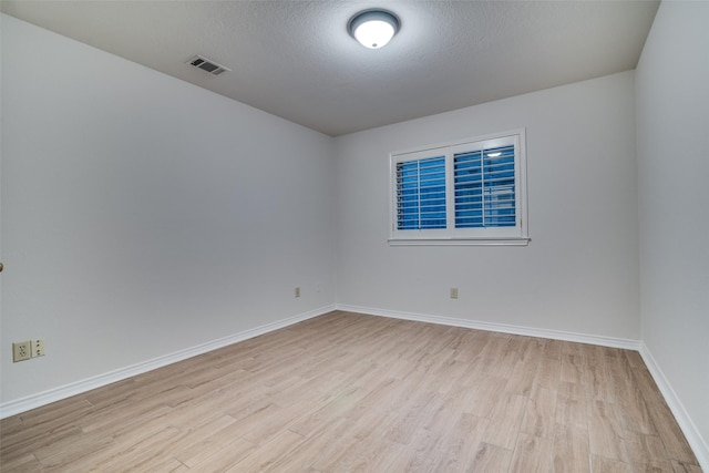 3824 Wyeth Dr, Plano, TX 75023 - spare room with light wood-type flooring, baseboards, and a textured ceiling