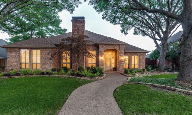 3824 Wyeth Dr, Plano, TX 75023 - french country style house featuring brick siding, a shingled roof, and a chimney