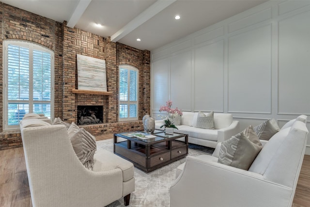 3824 Wyeth Dr, Plano, TX 75023 - living room with a decorative wall, beam ceiling, healthy amount of natural light, wood finished floors, and a brick fireplace