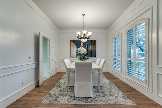 3824 Wyeth Dr, Plano, TX 75023 - dining room featuring a chandelier, ornamental molding, and dark wood-type flooring