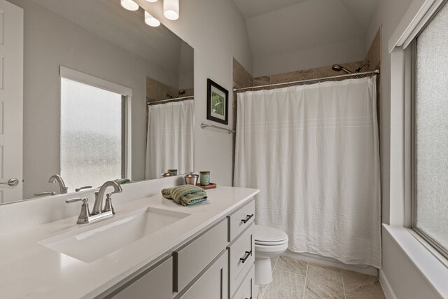 bathroom featuring healthy amount of natural light, toilet, vanity, and shower / bath combination with curtain