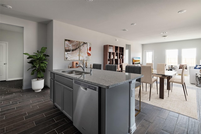 1910 Blackbird Ln, Princeton, TX 75407 - kitchen featuring dishwasher, a sink, wood tiled floors, an island with sink, and open floor plan
