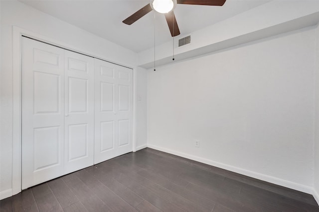 4325 Madera Rd, Irving, TX 75038 - unfurnished bedroom featuring dark wood-style flooring, baseboards, a closet, and a ceiling fan