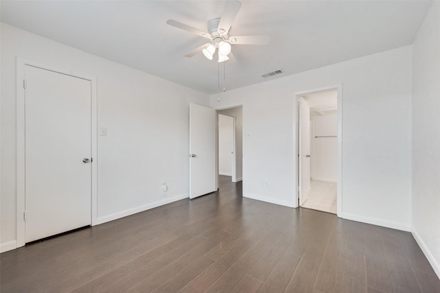 4325 Madera Rd, Irving, TX 75038 - unfurnished bedroom featuring dark wood finished floors, baseboards, and a ceiling fan
