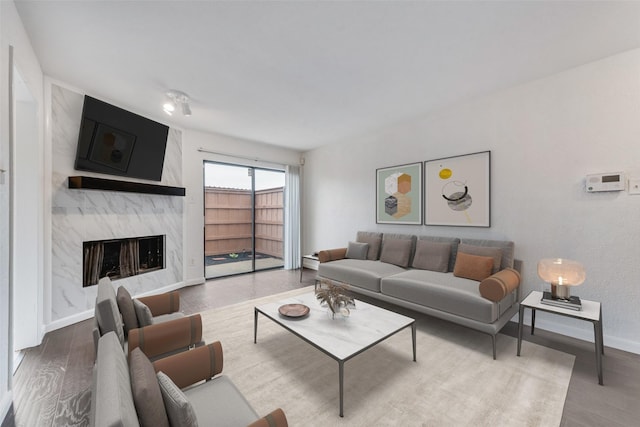 4325 Madera Rd, Irving, TX 75038 - living room featuring wood finished floors, a premium fireplace, and baseboards