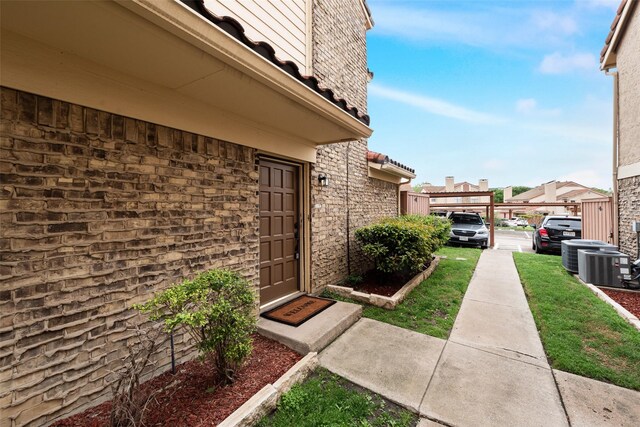 4325 Madera Rd, Irving, TX 75038 - entrance to property featuring central air condition unit and stone siding