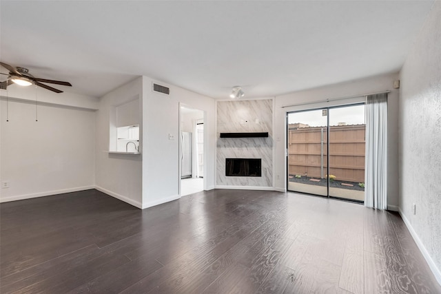 4325 Madera Rd, Irving, TX 75038 - unfurnished living room with ceiling fan, wood finished floors, a premium fireplace, and baseboards