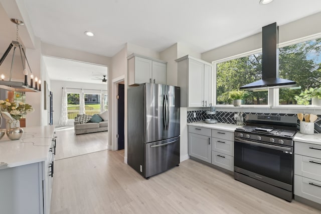 702 Griffith, Terrell, TX 75160 - kitchen featuring appliances with stainless steel finishes, extractor fan, light wood-style flooring, tasteful backsplash, and recessed lighting