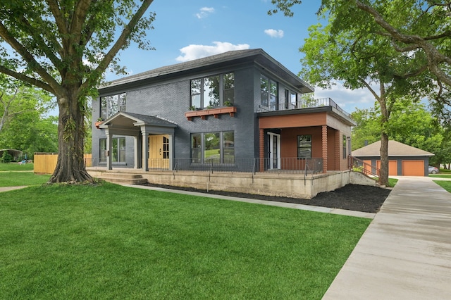 702 Griffith, Terrell, TX 75160 - contemporary home featuring a detached garage, a front yard, brick siding, an outdoor structure, and a porch
