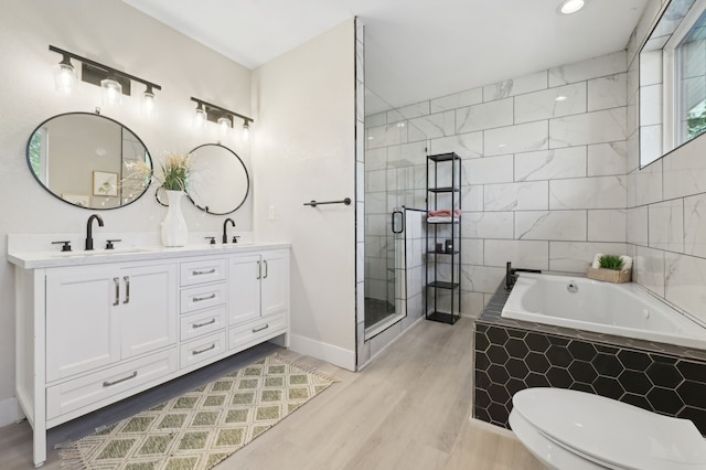 702 Griffith, Terrell, TX 75160 - full bathroom with a garden tub, wood finished floors, double vanity, a stall shower, and toilet
