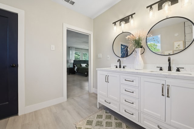 702 Griffith, Terrell, TX 75160 - full bathroom featuring double vanity, wood finished floors, and baseboards