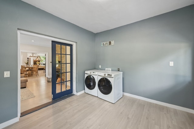 702 Griffith, Terrell, TX 75160 - washroom featuring separate washer and dryer, light wood-type flooring, and baseboards