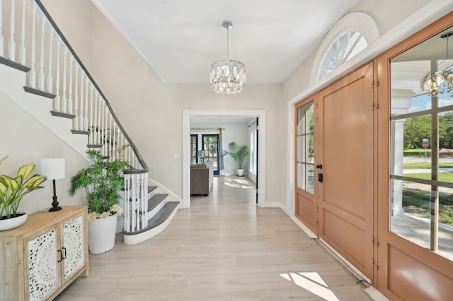 702 Griffith, Terrell, TX 75160 - foyer entrance with a chandelier, light wood-type flooring, and stairway