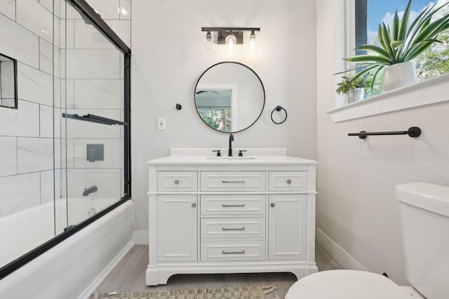 702 Griffith, Terrell, TX 75160 - full bathroom featuring toilet, baseboards, vanity, wood finished floors, and enclosed tub / shower combo