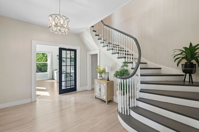 702 Griffith, Terrell, TX 75160 - foyer entrance featuring stairway, baseboards, wood finished floors, a chandelier, and french doors