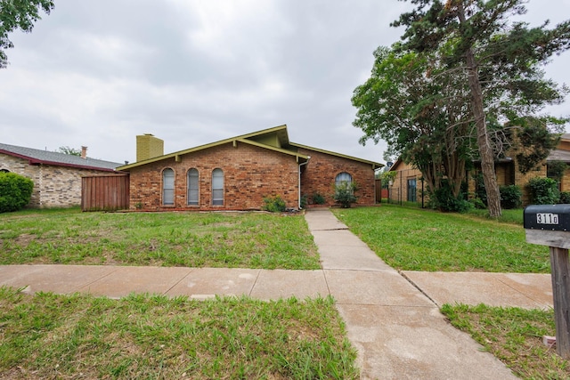 3110 Nutmeg Ln, Garland, TX 75044 - view of front of house with brick siding and a chimney