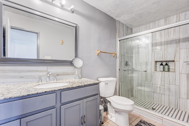 3110 Nutmeg Ln, Garland, TX 75044 - full bath featuring toilet, a shower stall, vanity, a textured ceiling, and tile patterned floors