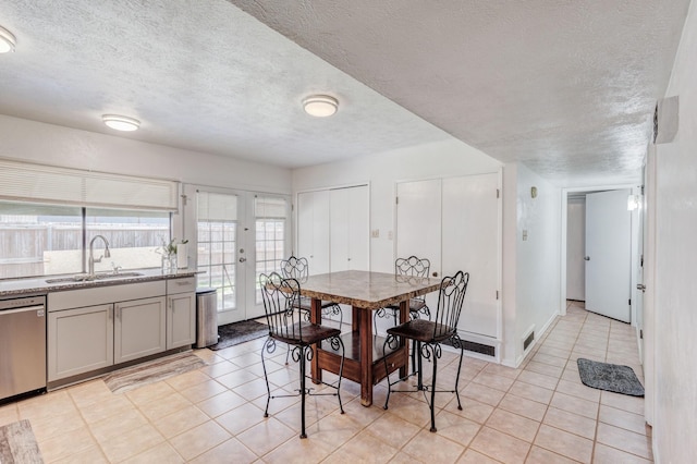 3110 Nutmeg Ln, Garland, TX 75044 - dining area with a textured ceiling and light tile patterned flooring