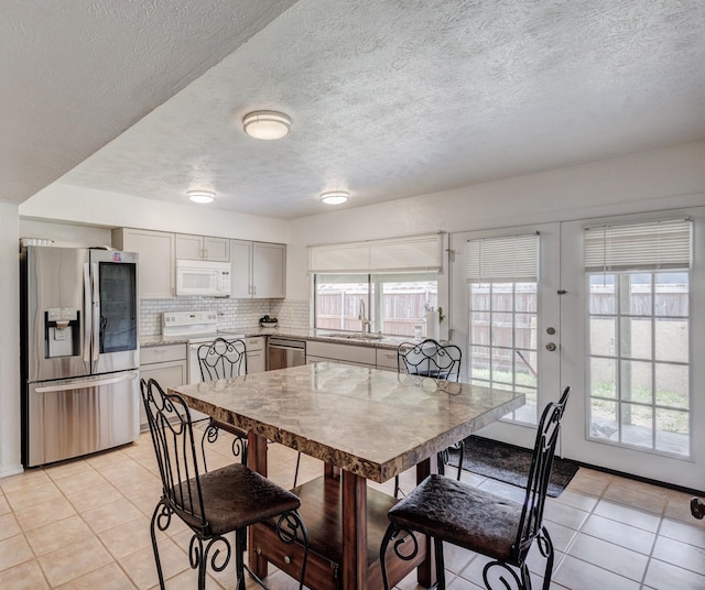 3110 Nutmeg Ln, Garland, TX 75044 - dining area with light tile patterned floors and a textured ceiling