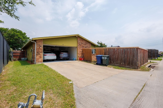 3110 Nutmeg Ln, Garland, TX 75044 - view of side of home featuring an attached garage, concrete driveway, and brick siding