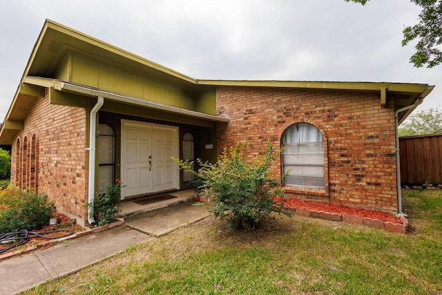 3110 Nutmeg Ln, Garland, TX 75044 - doorway to property featuring brick siding and a yard