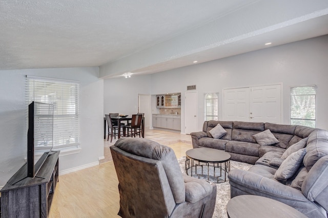 3110 Nutmeg Ln, Garland, TX 75044 - living area with vaulted ceiling, plenty of natural light, light wood-style floors, baseboards, and recessed lighting