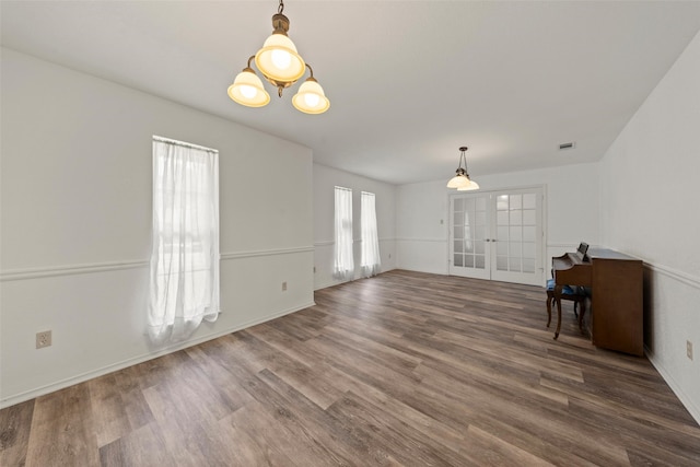 1812 Trinity Dr, Waco, TX 76710 - empty room featuring french doors, wood finished floors, and baseboards
