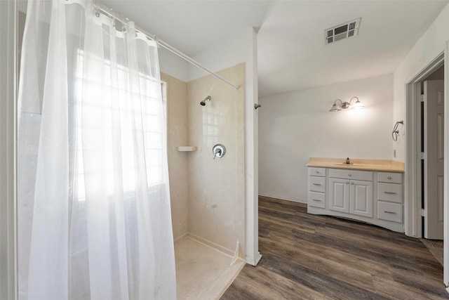 1812 Trinity Dr, Waco, TX 76710 - bathroom with curtained shower, wood finished floors, and vanity