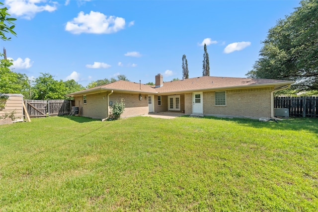 1812 Trinity Dr, Waco, TX 76710 - rear view of house with french doors, brick siding, a chimney, and a gate