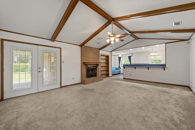 1812 Trinity Dr, Waco, TX 76710 - unfurnished living room with a brick fireplace, carpet, baseboards, a ceiling fan, and french doors