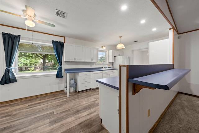 1812 Trinity Dr, Waco, TX 76710 - kitchen featuring white appliances, dark countertops, white cabinetry, a peninsula, and baseboards
