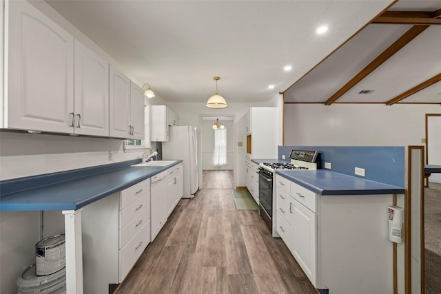 1812 Trinity Dr, Waco, TX 76710 - kitchen featuring white appliances, dark countertops, a sink, white cabinetry, and recessed lighting