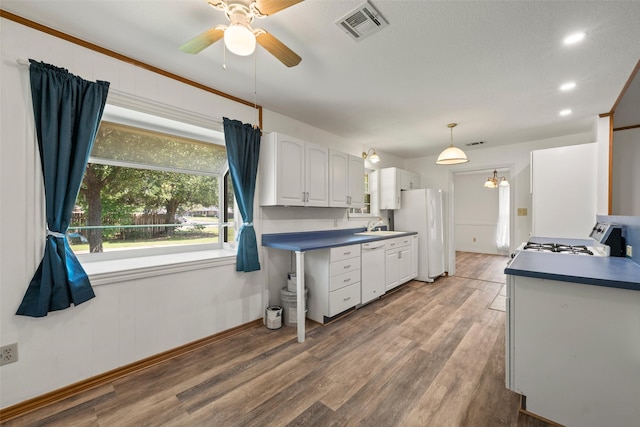 1812 Trinity Dr, Waco, TX 76710 - kitchen with white appliances, a sink, wood finished floors, white cabinetry, and a ceiling fan