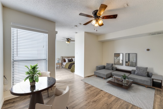 2301 Balsam Dr Unit F308, Arlington, TX 76006 - living area with a ceiling fan, wood finished floors, a textured ceiling, and baseboards